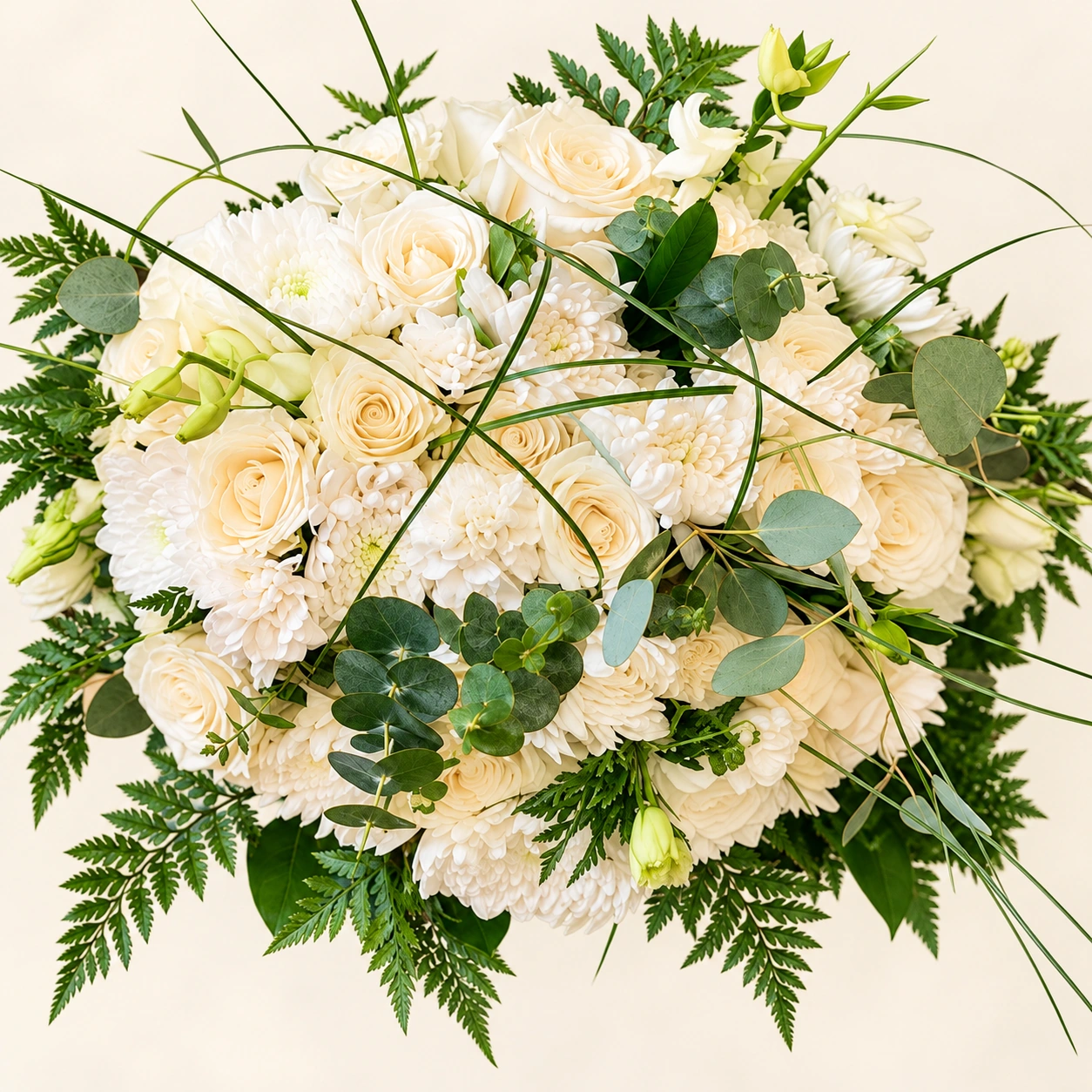 Ivory bridal bouquet with roses, chrysanthemums and eucalyptus against a bright ivory background